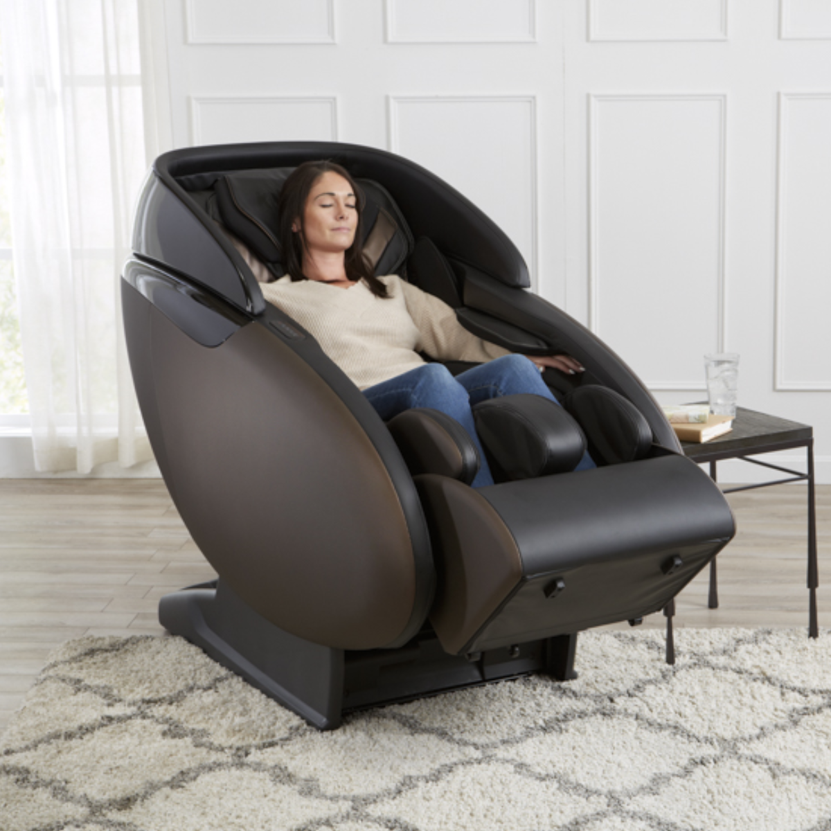 Kyota Kaizen Massage Chair M680 in Brown in interior reclined with a woman showing the body position during the massage - Home Bars USA